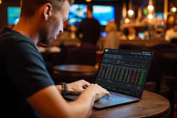 A confident dealer surrounded by casino chips inviting players to access their 599JILI account, reflecting quick and easy login options.